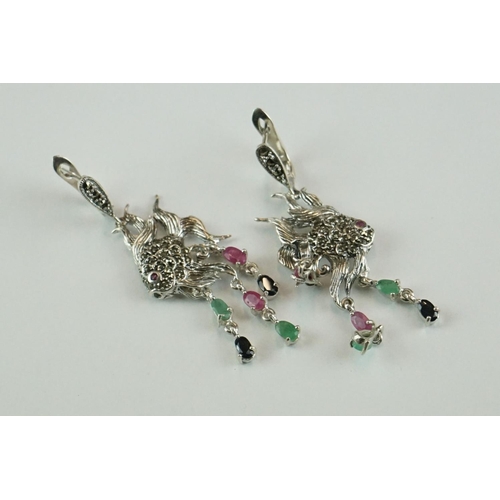 361 - A pair of silver angle fish earrings set with marcasites, ruby, sapphire and emeralds