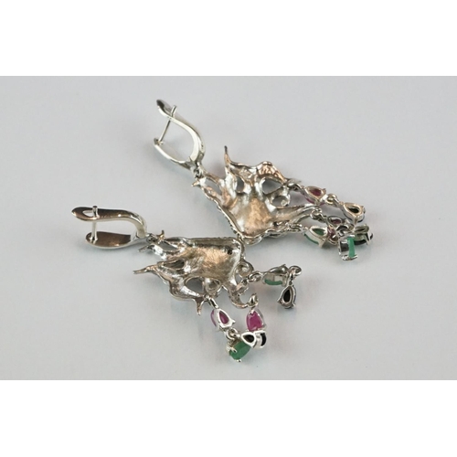 361 - A pair of silver angle fish earrings set with marcasites, ruby, sapphire and emeralds