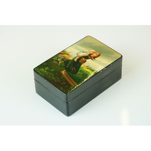 362 - A Russian lacquer box, signed Podwchicko (?) with a young mother carrying her child on her back, 10 ... 