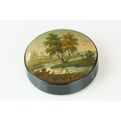 367 - A Russian lacquer circular box, signed, depicting a river landscape, 6cm diameter, together with ano... 