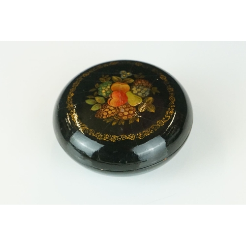 367 - A Russian lacquer circular box, signed, depicting a river landscape, 6cm diameter, together with ano... 