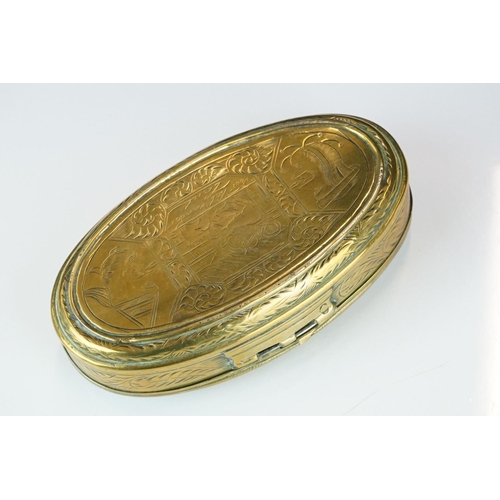 374 - An antique 18th century oval brass snuff box with ornate chased decoration.