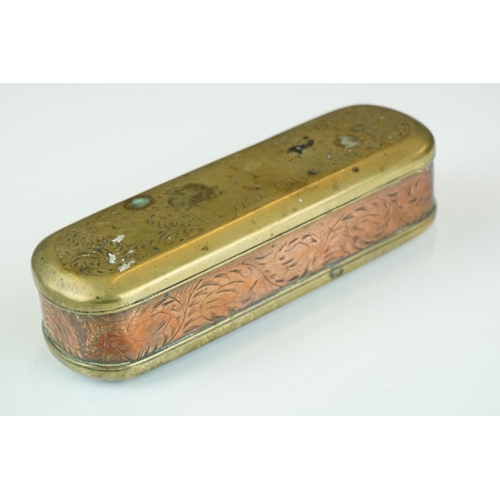 375 - An antique 18th century brass and copper snuff box with ornate chased decoration.