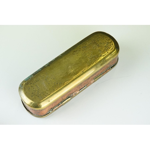 375 - An antique 18th century brass and copper snuff box with ornate chased decoration.