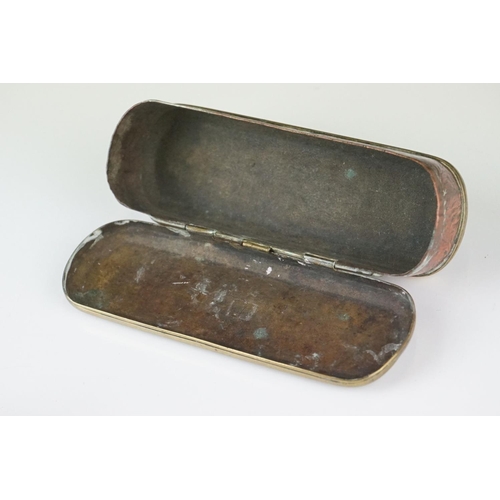 375 - An antique 18th century brass and copper snuff box with ornate chased decoration.