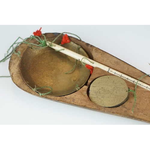 378 - An early 20th century opium scale with brass pan, bone handle and wooden fitted case.