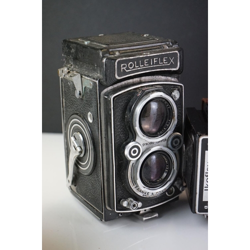 397 - A collection of mainly mid 20th century twin lens reflex cameras to include Rollei examples.