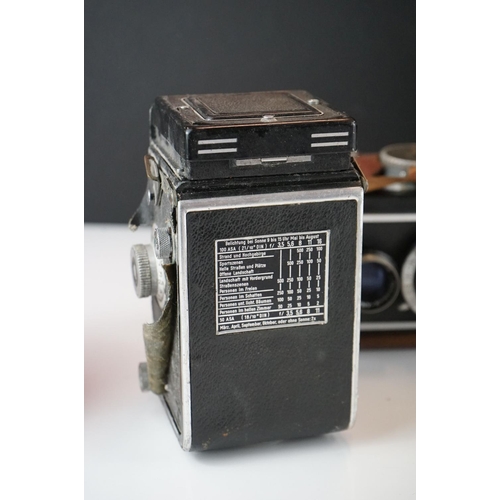 397 - A collection of mainly mid 20th century twin lens reflex cameras to include Rollei examples.