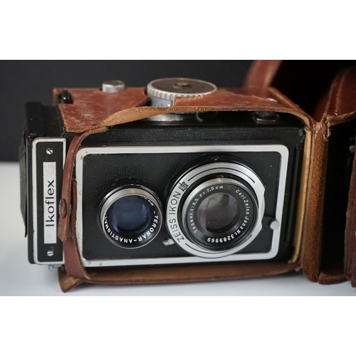 397 - A collection of mainly mid 20th century twin lens reflex cameras to include Rollei examples.