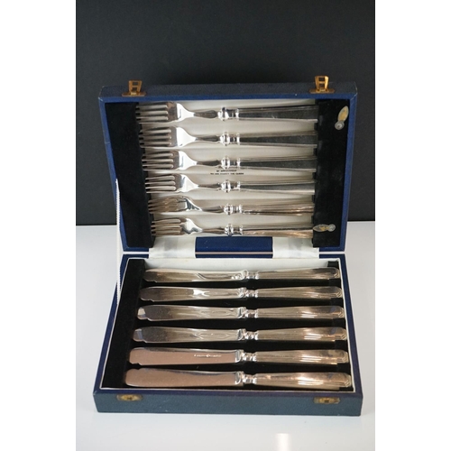 425 - A cased set of silver plated fish knives and forks.