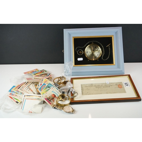 428 - A small group of mixed collectables to include watches, a framed cheque dated 1896, a clock and a co... 