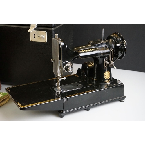 496 - A vintage electric singer sewing machine in fitted case with some accessories.