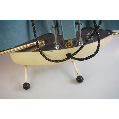 457 - Mid 20th Century heat lamp modelled as a yacht, with an aluminium sail and iron base, measures 78cm ... 