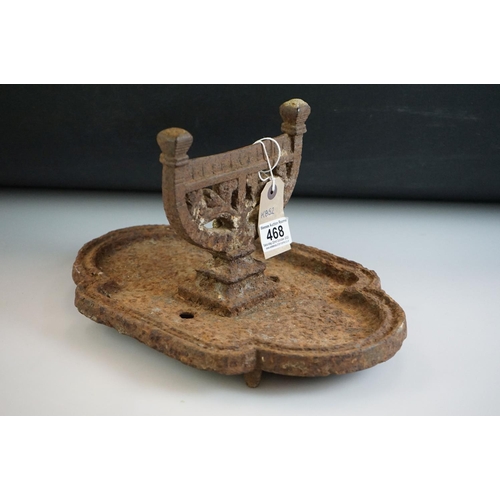 468 - A Victorian cast iron boot scraper, on a pierced rectangular base