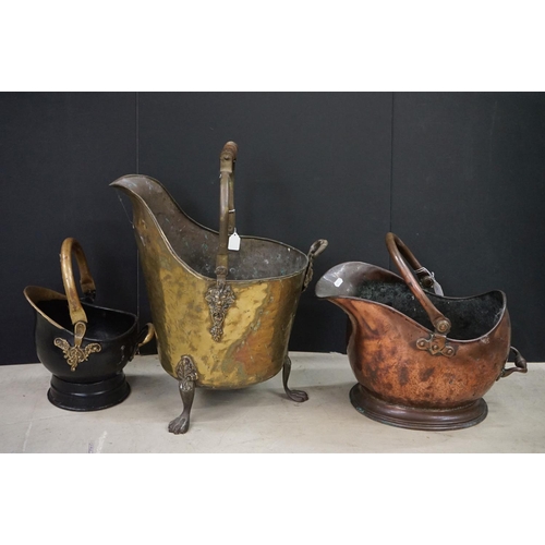 472 - Three coal scuttles to include an antique hammered brass coal scuttle raised on three claw feet, wit... 