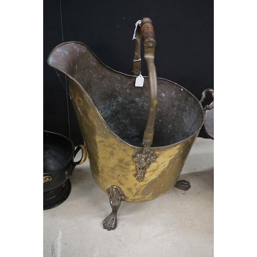 472 - Three coal scuttles to include an antique hammered brass coal scuttle raised on three claw feet, wit... 