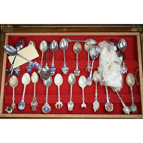 395 - A large collection of mainly silver plated collectors tea spoons contained within six wooden boxes.