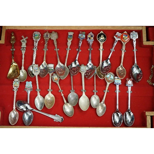 395 - A large collection of mainly silver plated collectors tea spoons contained within six wooden boxes.