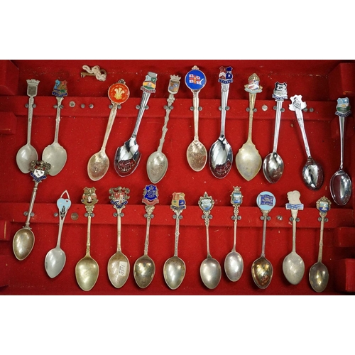 395 - A large collection of mainly silver plated collectors tea spoons contained within six wooden boxes.