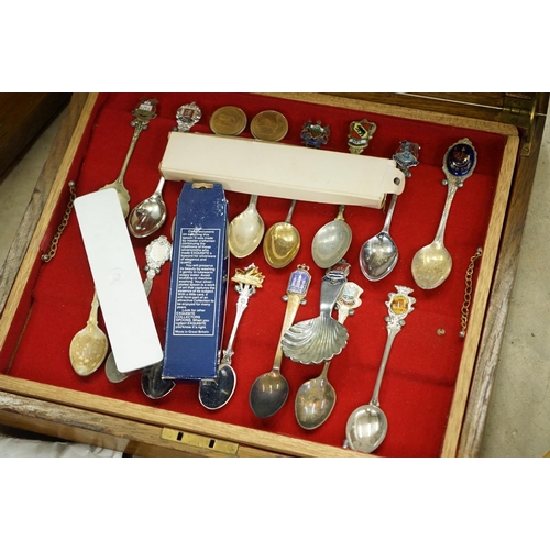 395 - A large collection of mainly silver plated collectors tea spoons contained within six wooden boxes.