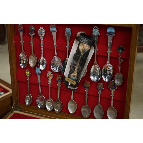 395 - A large collection of mainly silver plated collectors tea spoons contained within six wooden boxes.