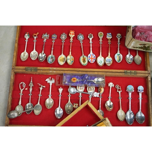 395 - A large collection of mainly silver plated collectors tea spoons contained within six wooden boxes.