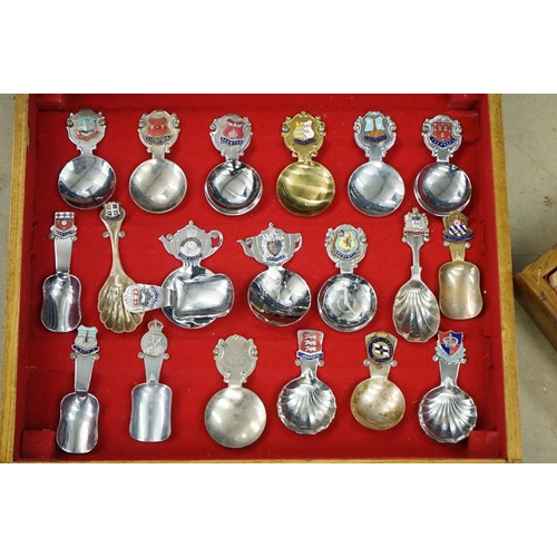 395 - A large collection of mainly silver plated collectors tea spoons contained within six wooden boxes.