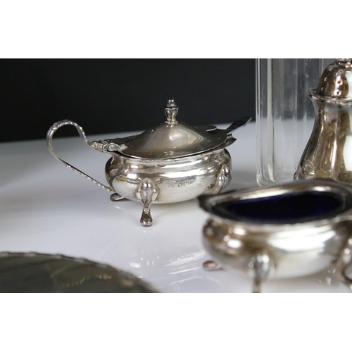 400A - A collection of fully hallmarked sterling silver to include hand mirror, brush, cruet set and table ... 