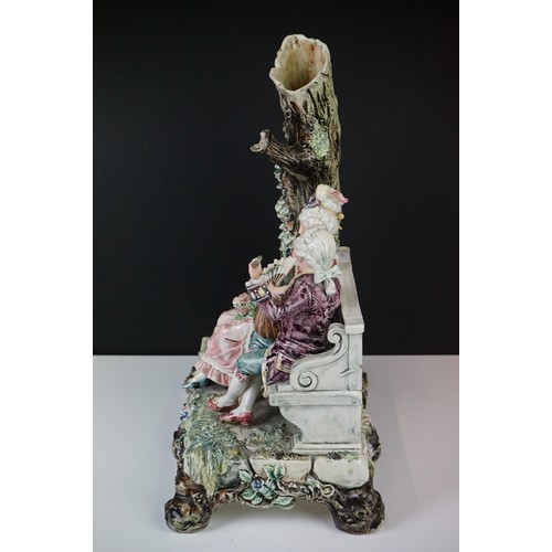 36 - 19th Century porcelain figural spill vase of a 19th Century courting couple on bench with tree, rais... 