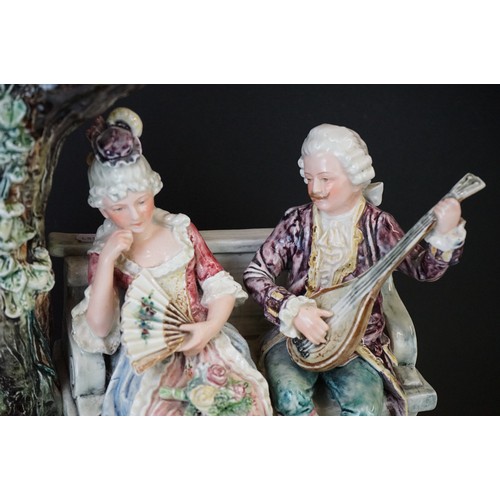 36 - 19th Century porcelain figural spill vase of a 19th Century courting couple on bench with tree, rais... 