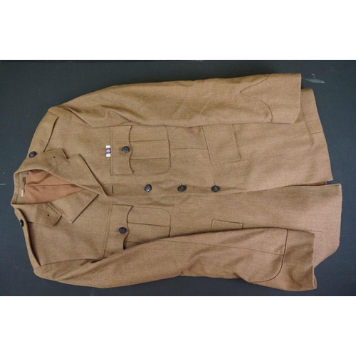 235 - A Large Collection Of Mixed Military Uniforms To Include British Battle Dress Trousers.