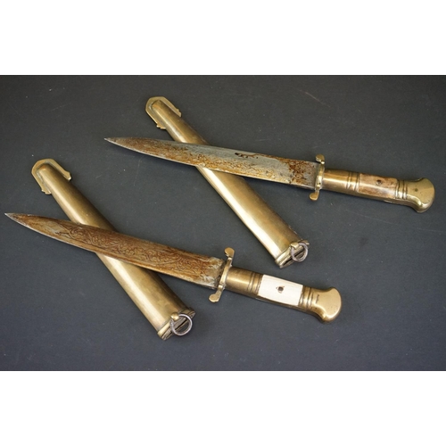 373 - Two Islamic Daggers With Decoratively Engraved Blades, Horn / Bone Handles And Brass Scabbards.