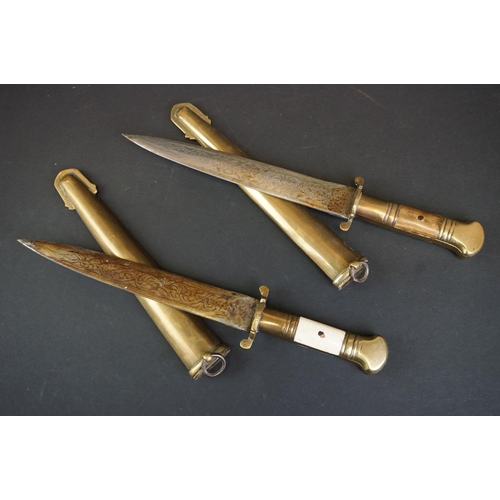 373 - Two Islamic Daggers With Decoratively Engraved Blades, Horn / Bone Handles And Brass Scabbards.