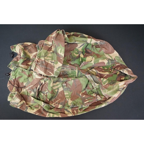 234 - A Large Collection Of Mixed Military Uniforms And Surplus Clothing.