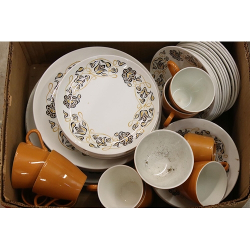 106 - Poole Pottery Dinner and Tea Ware decorated in two tone orange and white ground with a floral patter... 