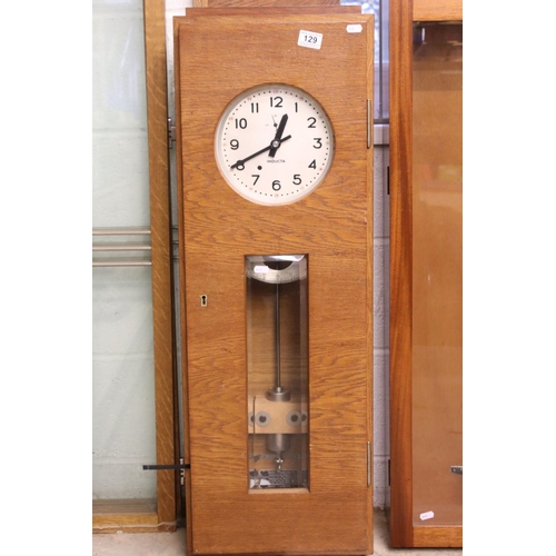 129 - Mid century Oak Cased ' Inducta ' Electric Clock, the 8.5