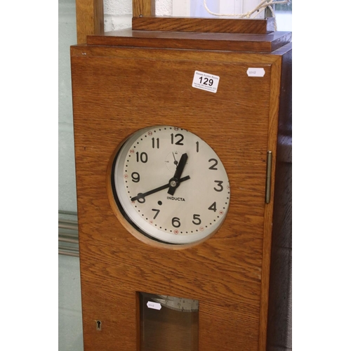 129 - Mid century Oak Cased ' Inducta ' Electric Clock, the 8.5