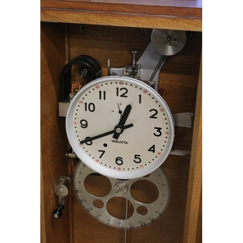 129 - Mid century Oak Cased ' Inducta ' Electric Clock, the 8.5