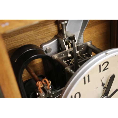 129 - Mid century Oak Cased ' Inducta ' Electric Clock, the 8.5