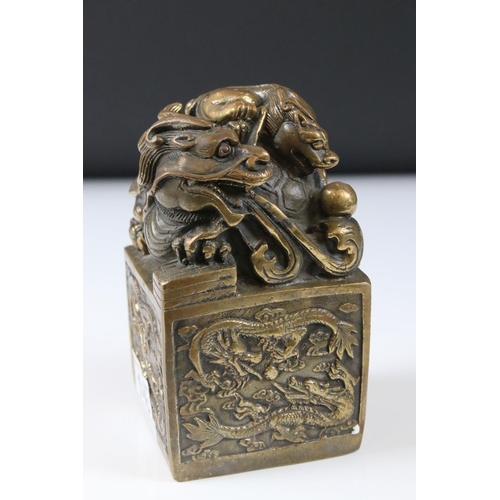 148 - Large Chinese Bronze Seal surmounted by dragons, 14cm high