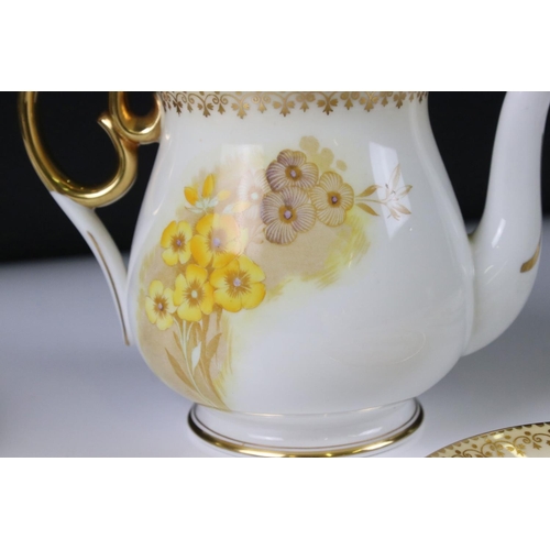 16 - Shelley Tea for Two Set, gilt and yellow flower decoration, comprising Tea Pot, Two Tea Cups, Two Sa... 