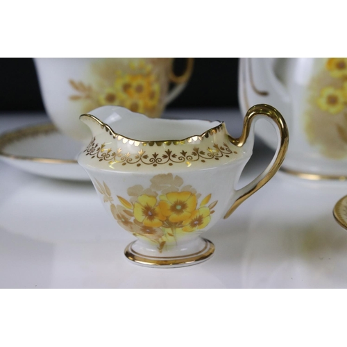 16 - Shelley Tea for Two Set, gilt and yellow flower decoration, comprising Tea Pot, Two Tea Cups, Two Sa... 