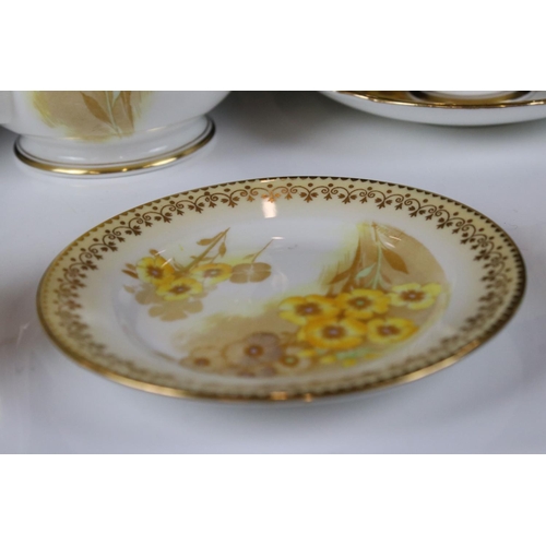 16 - Shelley Tea for Two Set, gilt and yellow flower decoration, comprising Tea Pot, Two Tea Cups, Two Sa... 