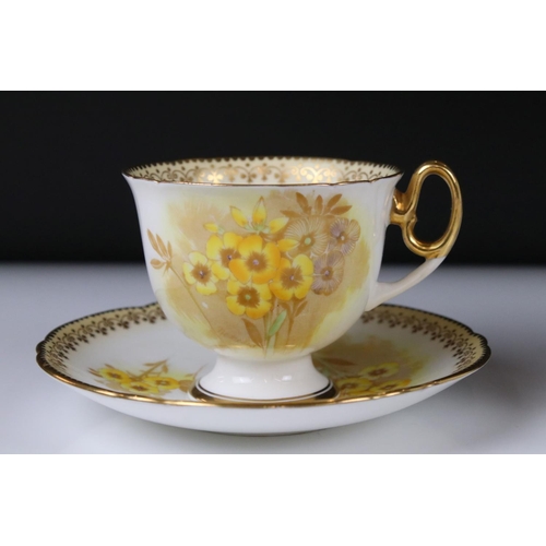 16 - Shelley Tea for Two Set, gilt and yellow flower decoration, comprising Tea Pot, Two Tea Cups, Two Sa... 