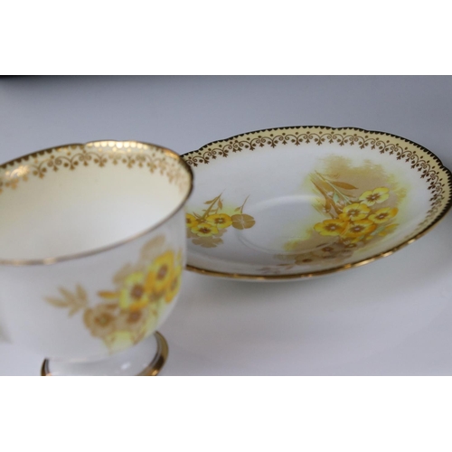 16 - Shelley Tea for Two Set, gilt and yellow flower decoration, comprising Tea Pot, Two Tea Cups, Two Sa... 