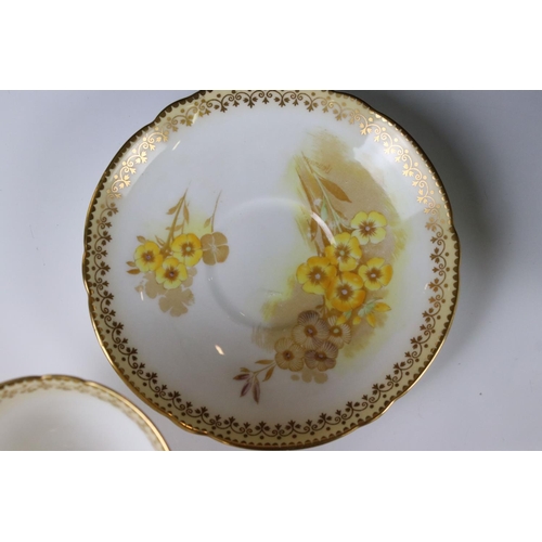 16 - Shelley Tea for Two Set, gilt and yellow flower decoration, comprising Tea Pot, Two Tea Cups, Two Sa... 