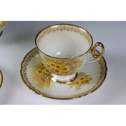 16 - Shelley Tea for Two Set, gilt and yellow flower decoration, comprising Tea Pot, Two Tea Cups, Two Sa... 