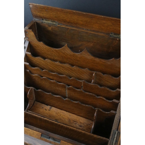 163 - Victorian Oak Stationery Cabinet, the pair of sloping doors opening to a fitted interior, drawer to ... 