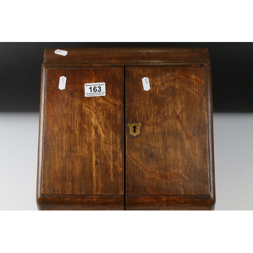 163 - Victorian Oak Stationery Cabinet, the pair of sloping doors opening to a fitted interior, drawer to ... 