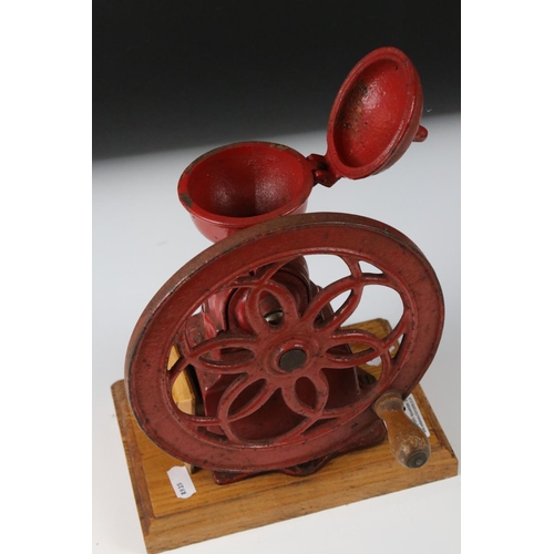 175 - Early to Mid 20th century Red Cast Iron ' National ' Coffee Grinder mounted on a wooden base, 23cm h... 